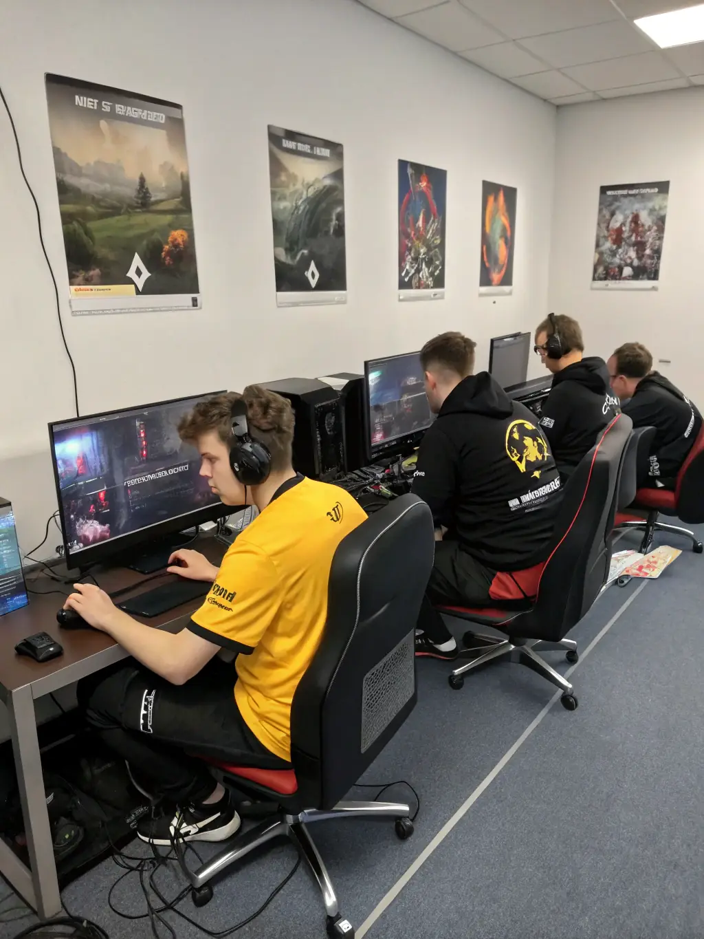 A group of DELTA-LAN members working together on a community project, such as setting up gaming equipment for a local charity event.